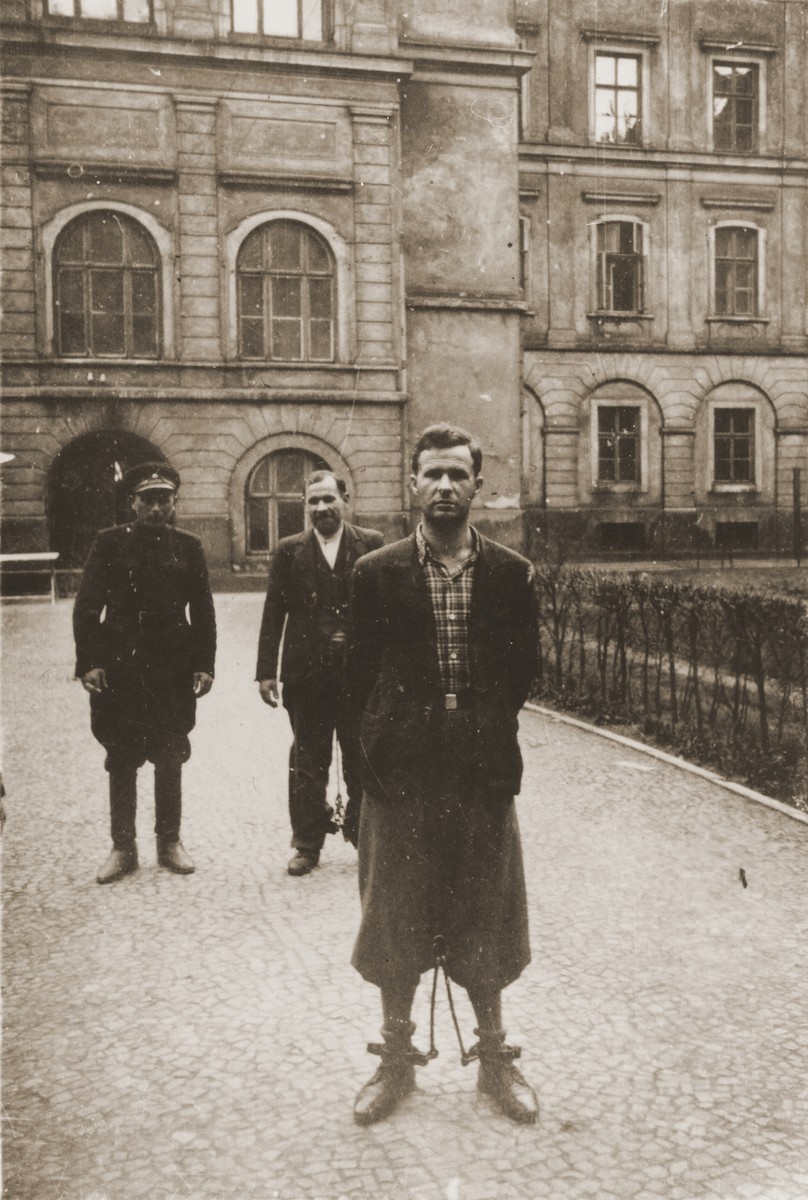 The Polish prisoner Heinrich Skowron (b. February 1912) poses in the courtyard of the county courthouse in Rzeszow.  The special [SS] court sentenced him to death on April 23 and executed him on August 20, 1940.