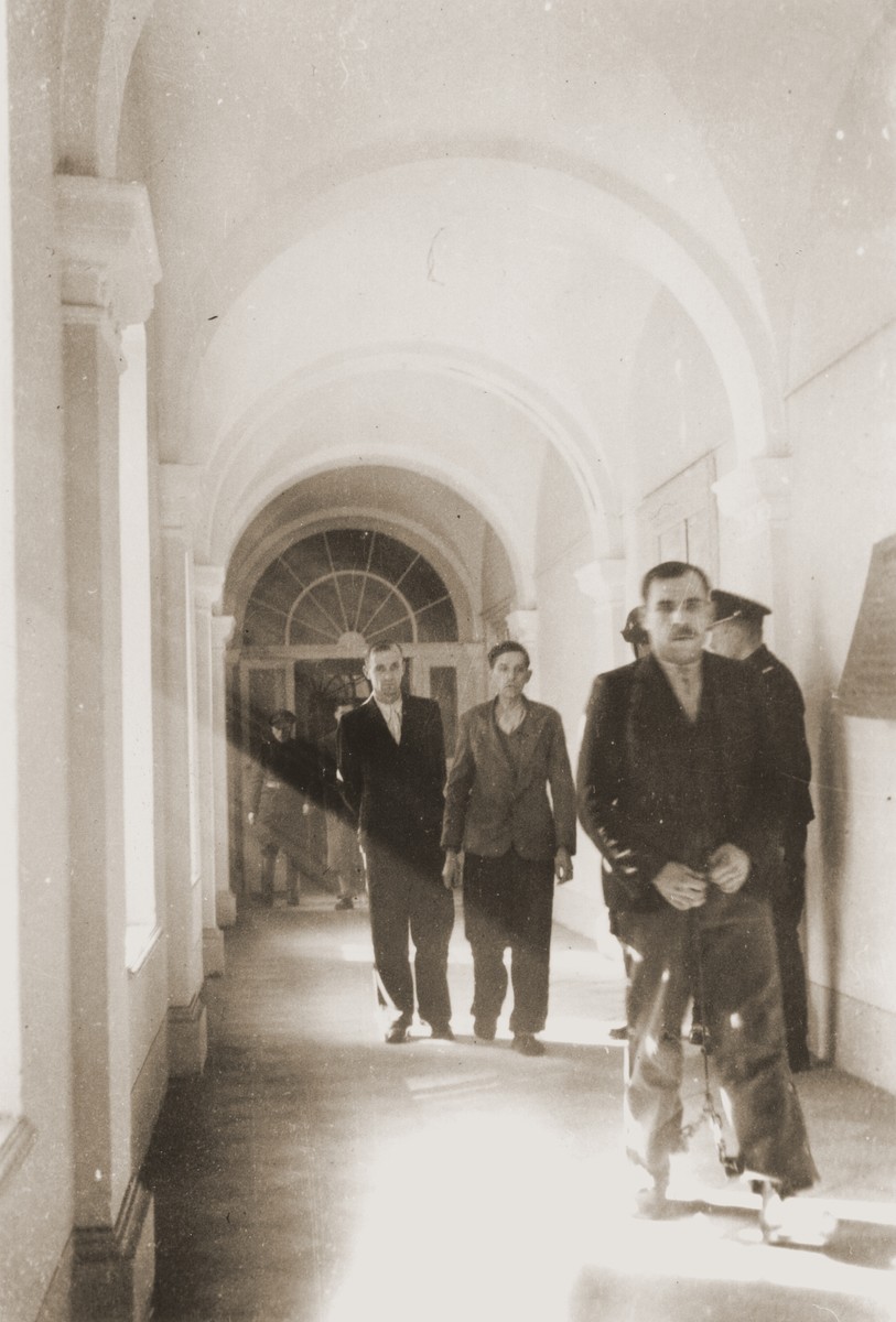 The Polish prisoner Siegmunt Swider (b. May 6, 1906) is led down the hall of the county courthouse in Rzeszow.  The special [SS] court sentenced him to death on April 23 and executed him on August 20, 1940.