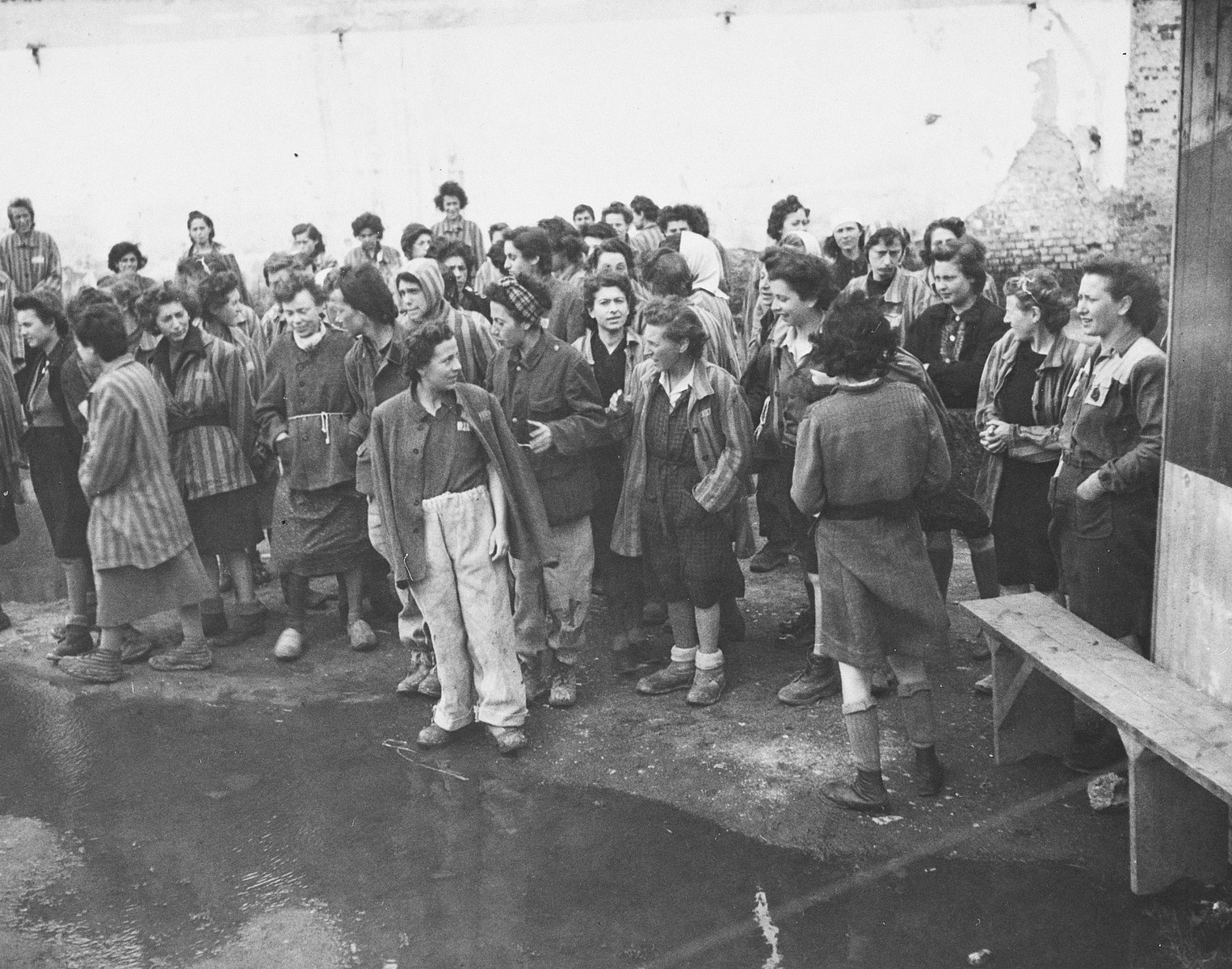 Female survivors gather outside a barracks in the newly liberated Lenzing concentration camp.