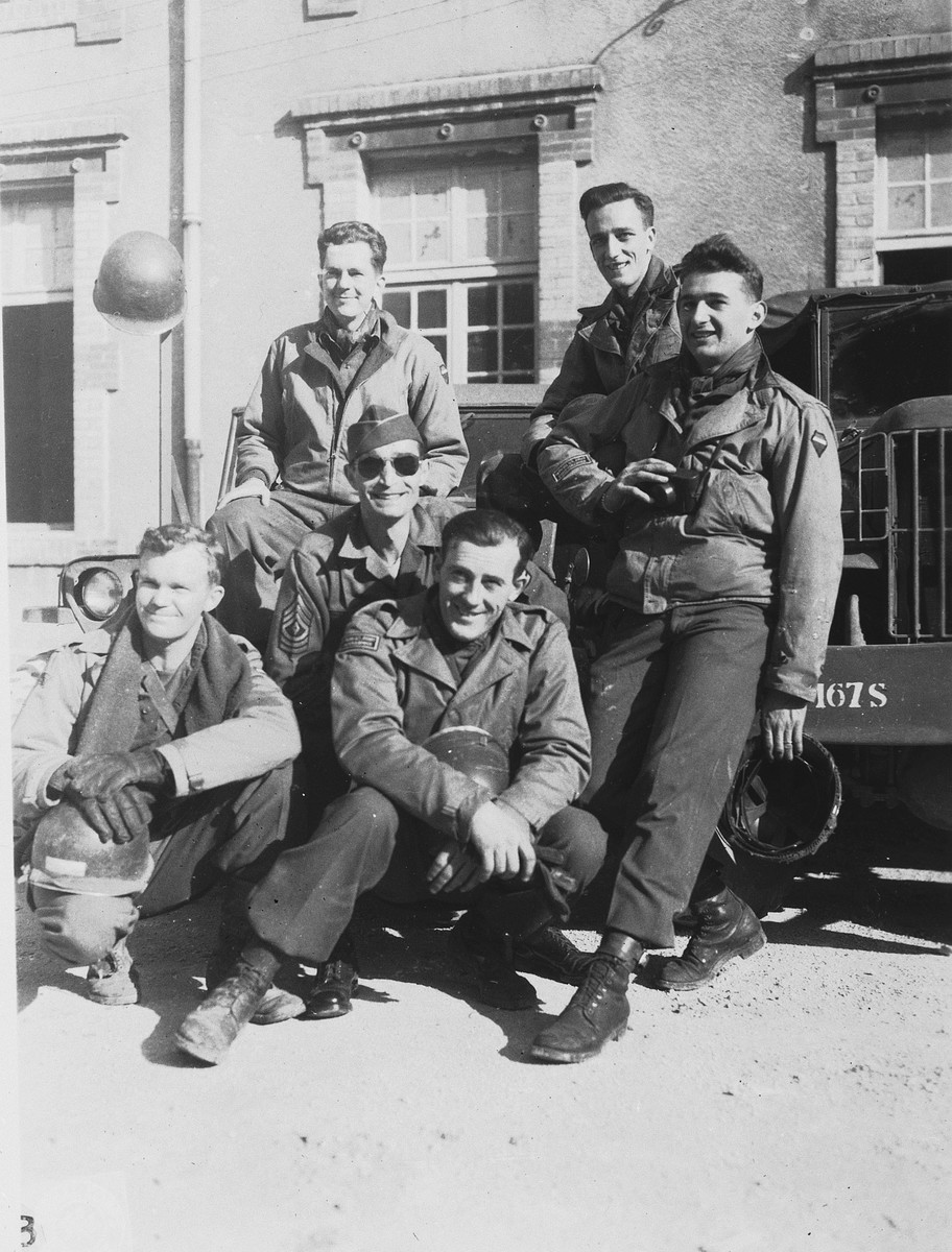 Group portrait of members of Combat Unit 123, a unit of the U.S. Army 167th Signal Photo Company.

Pictured in front from left to right are: Walt MacDonald and Eddie Urban.  In the middle is Gene Coogan; at the right is J Malan Heslop; behind from left to right are Arnold Samuelson and John O'Brien.