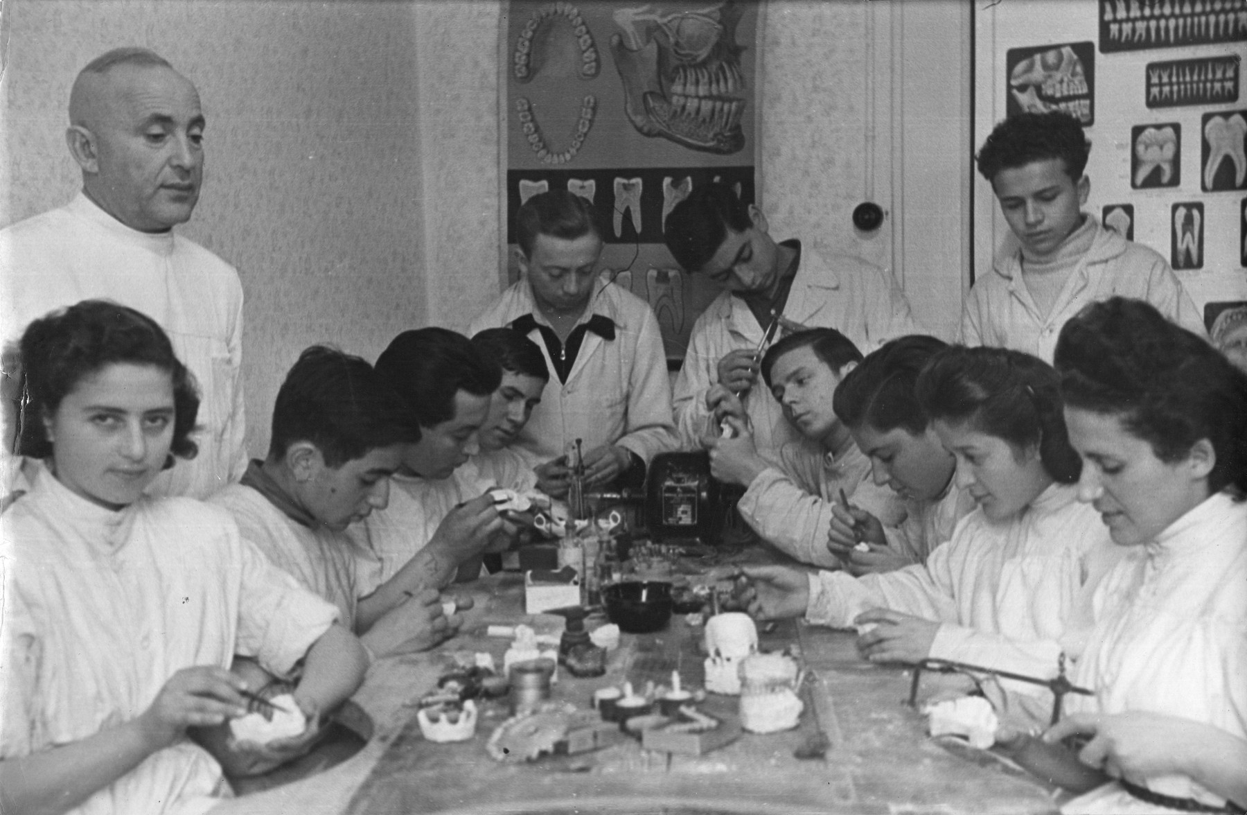Young men and women learn dentistry in an ORT (Organization for Rehabilitation through Training) vocational program in the Landsberg displaced persons' camp. [Oversized print]