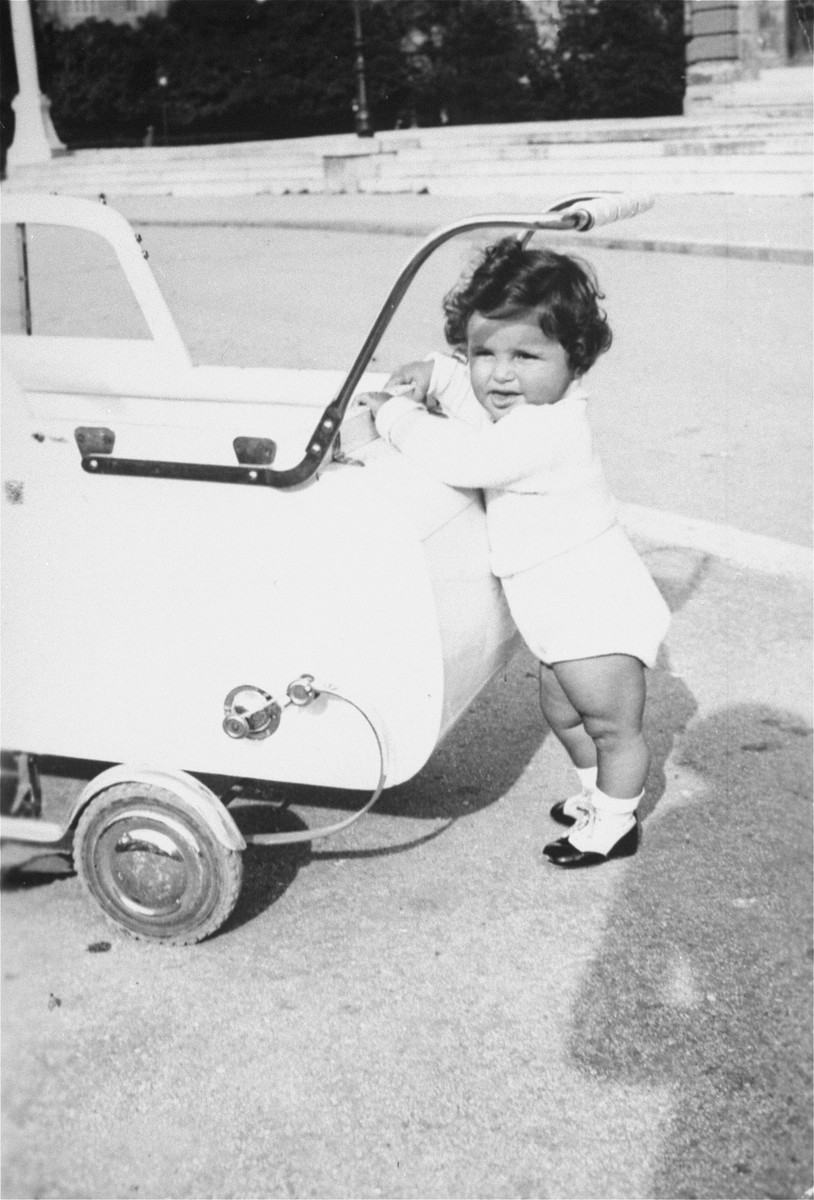 A Jewish child pushes a baby carriage along a street in Zagreb, Croatia.

Pictured is Dita Klein, the daughter of Zdenko Klein and a cousin of the donor.  Dita perished during the Holocaust.