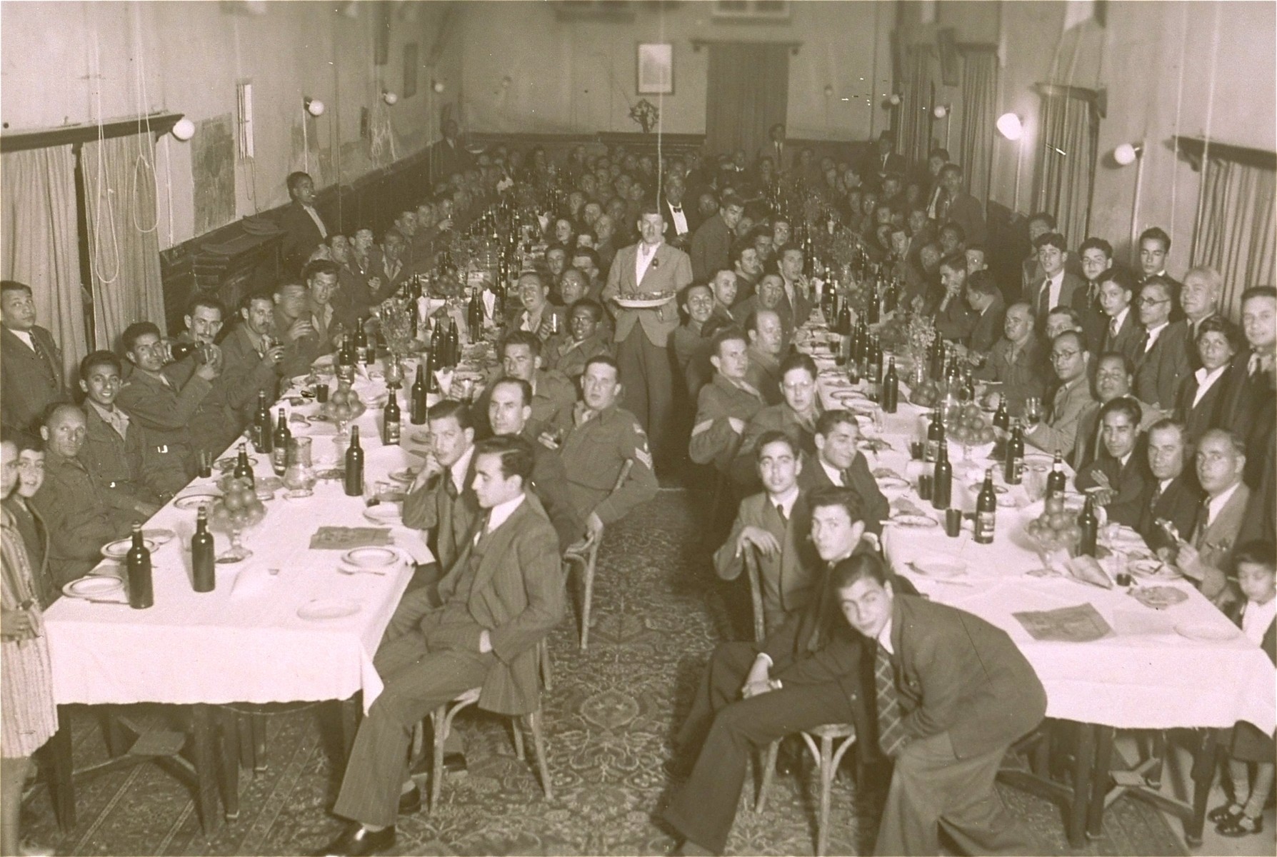 A group of Jewish soldiers in the British army, local Iraqi Jews and Jewish Americans serving in the Air Force and the Army, at a Passover Seder in Baghdad.  The Seder was conducted by the British army chaplain, Rabbi Brody.