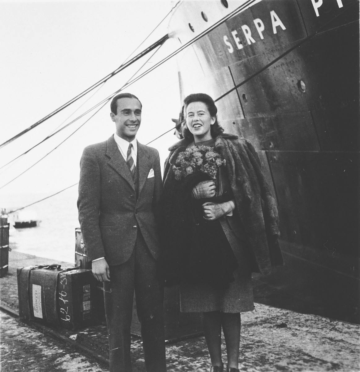 A Jewish refugee couple poses on the pier in the port of Lisbon before boarding the SS Serpa Pinto.

Pictured is Madeleine Hecht Feher and boyfriend, Rui Furerstenau who accompanied Madeleine to the ship to say goodbye before she embarked.