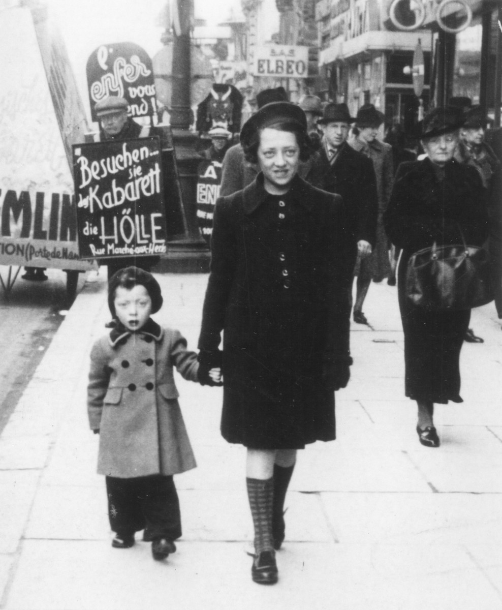 Austrian-Jewish refugees walk along a commercial street in central Brussels.  

Pictured are the donor's two nieces, Dorrit and Erika Trost.  The sisters were deported and killed in Auschwitz.