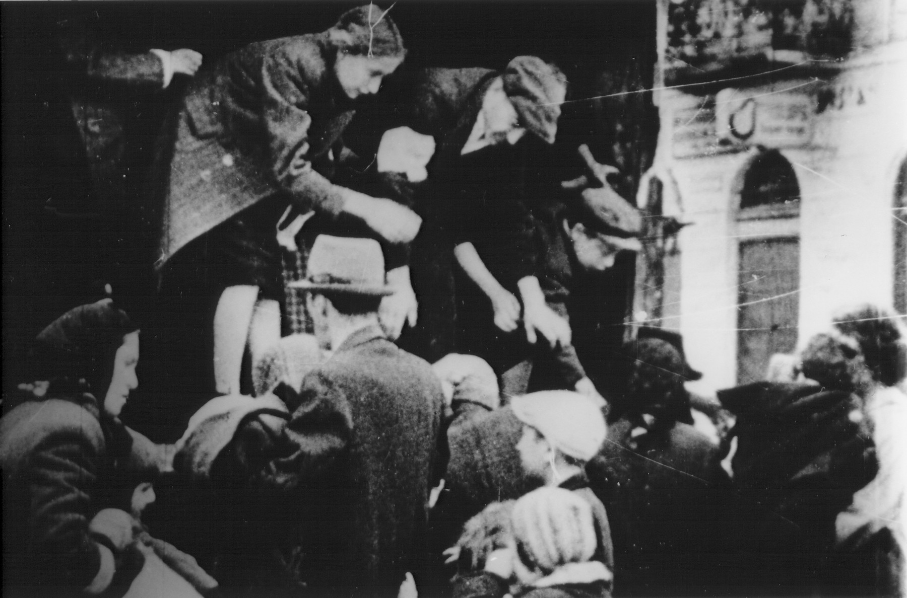 Jews captured by the SS during the suppression of the Warsaw ghetto uprising board a truck.