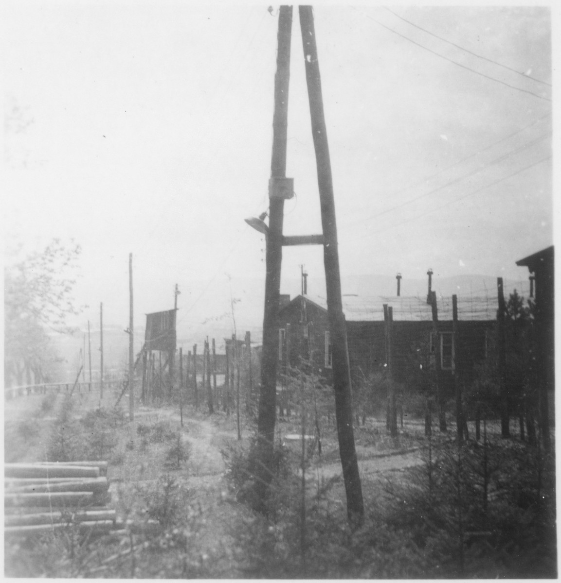 View of a guard tower and the barbed-wire fence that enclosed the Ohrdruf concentration camp.
