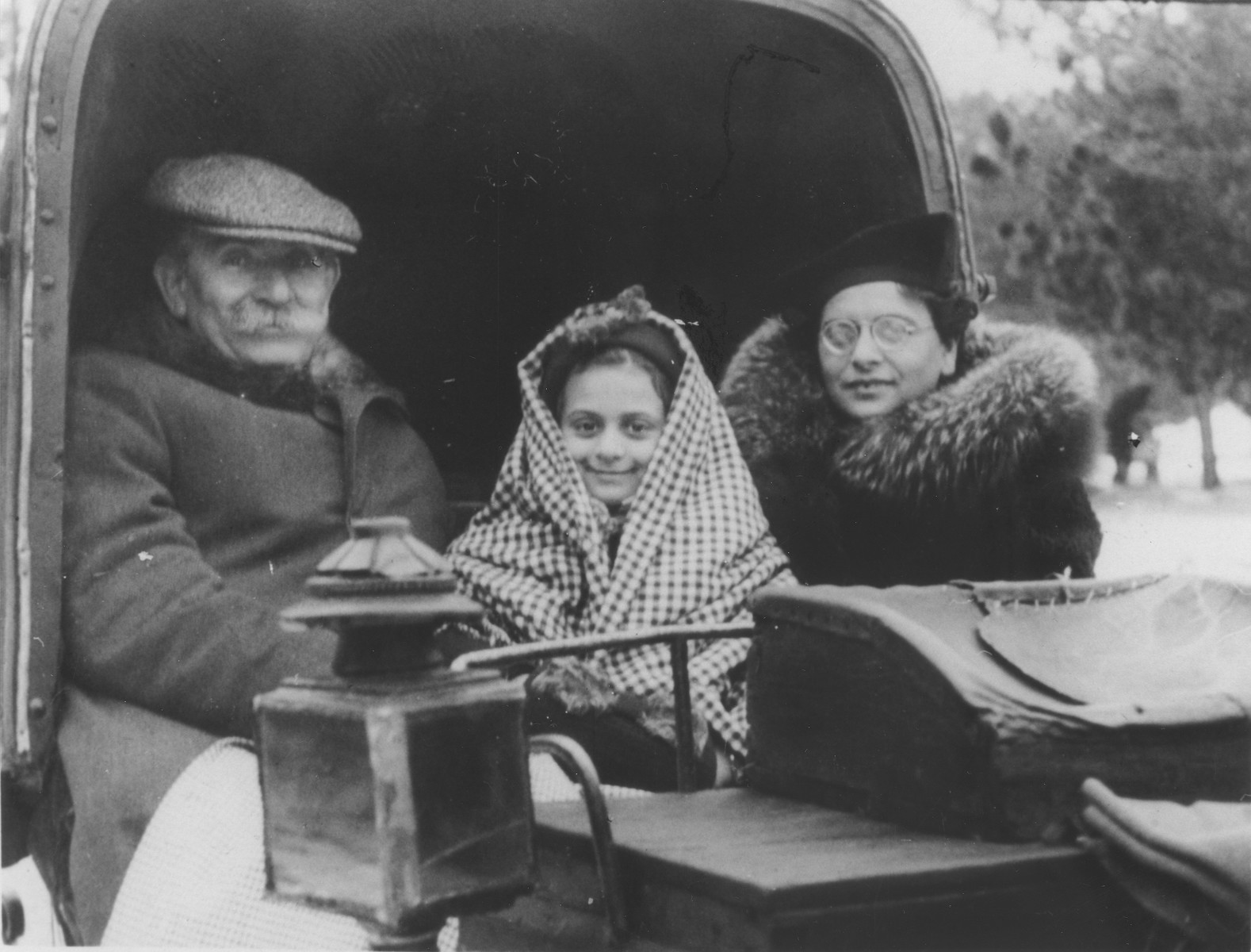 Basia Berkowicz rides in a carriage with her mother and another relative in Otwock, Poland.

Pictured from left to right are: Natan Taca, Basia Berkowicz and Bina Berkowicz.
