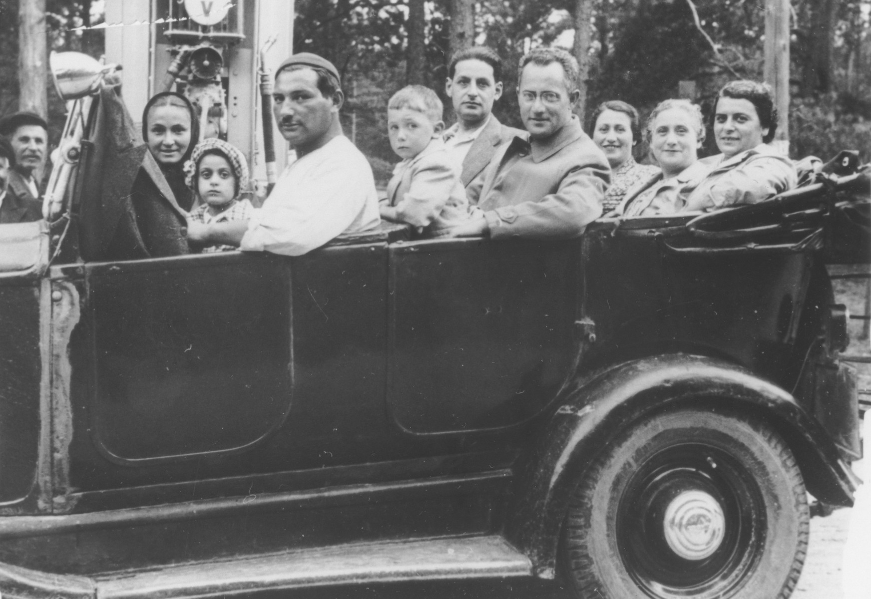 The Berkowicz and Eisenberg families go for a car ride while on vacation in Druskieniki, Poland.

Pictured from left to right are Anka (Basia's nanny), Basia Berkowicz, the driver, Amnon Eisenberg, Josef Pentelka, Chaim Ber Berkovicz, Rachela (Berkowicz) Pentelka , Sonia (Berkowicz) Eisenberg and Bina Berkowicz.