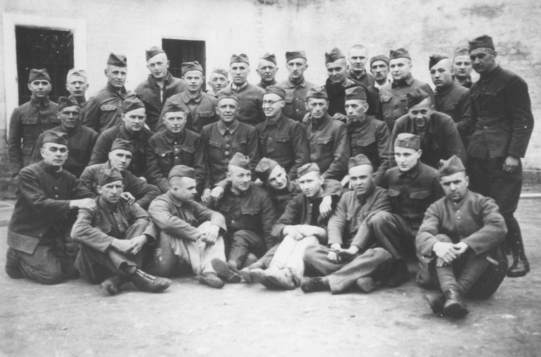 Group portrait of Czech political prisoners who shared a cell bloc in Theresienstadt.

Oskar Bartolsic is pictured in the front row, second from the left.