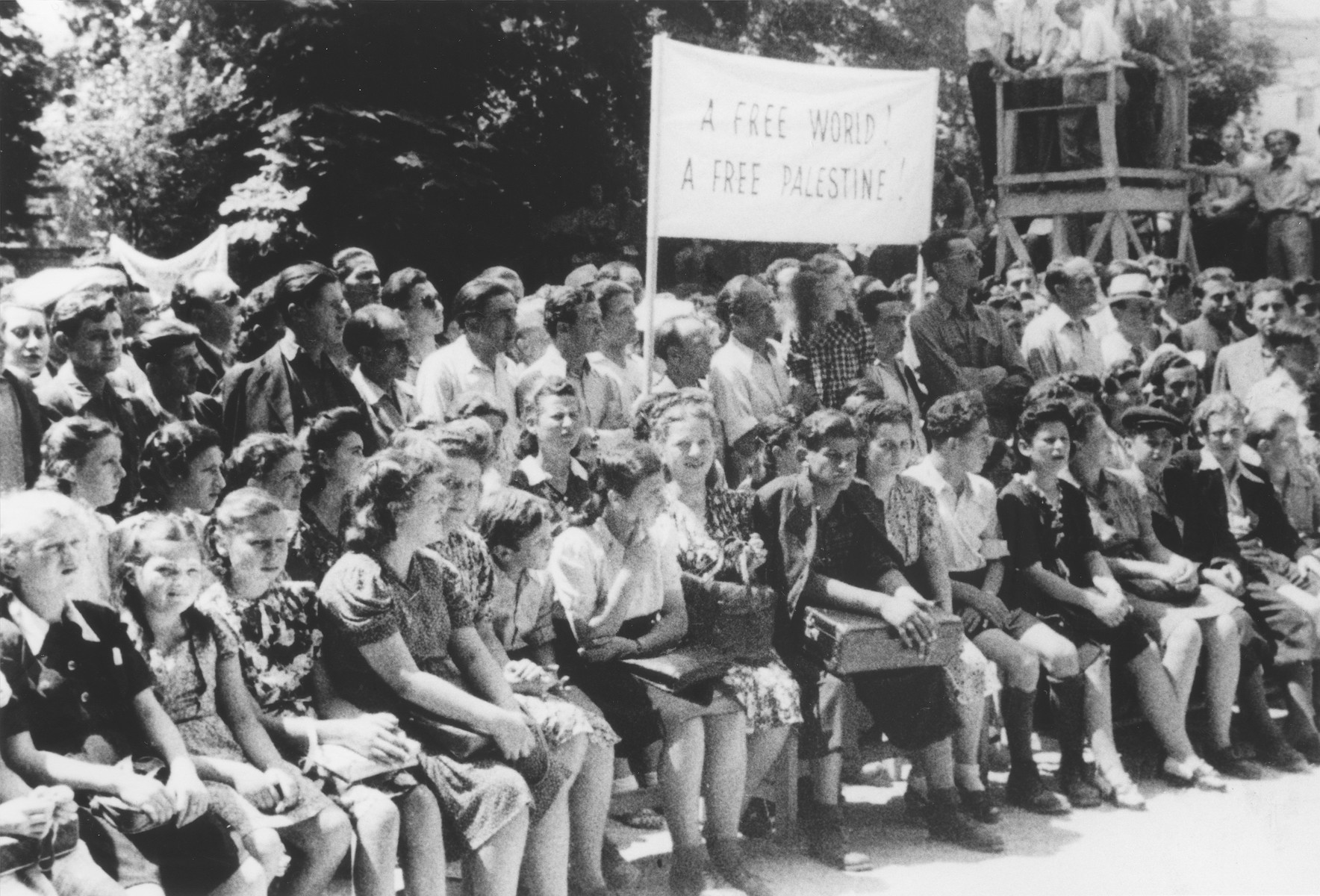 Students at a school for Jewish DPs in Munich, attend a demonstration calling for free immigration to Palestine.

Among those pictured is Ellen Griliches (front row, third from the left).