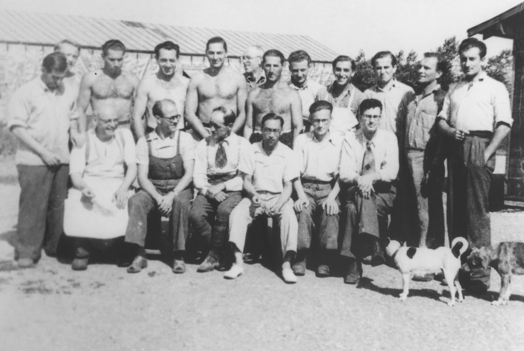Group portrait of foreign workers assigned to the food supply department at the Gurs internment camp.

Two of those pictured, Bustamante and Vigo, were former members of the Spanish Republican army.  Vigo had been the mayor of Badalona.  All the others were Jewish. 

Seated from left to right are Jakob Dreyfus, Bustamante, Francois Marine, Pedro Vigo Giro, Szlama Szmaragd and René Karschon.  Standing are Vogelsang, Walter Todt, Ossi Kohut, Sepp Grumkin, Hayek, Reinach, Alex Gruber, Franz Wrobel, Pauli Kupferberg, Kurt de Jonghe, Zaiakowski and Kurt Mautner.