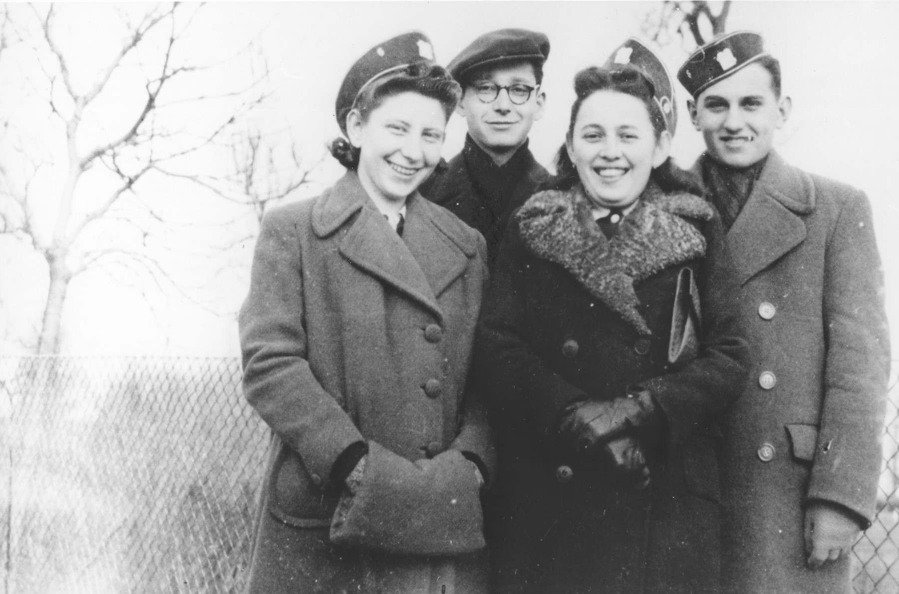Four students from the Hebrew gymnasium in Mukachevo pose wearing their school caps.

Pictured from left to right are: Miriam Katz, Eva Braun and Bela Grunbaum.