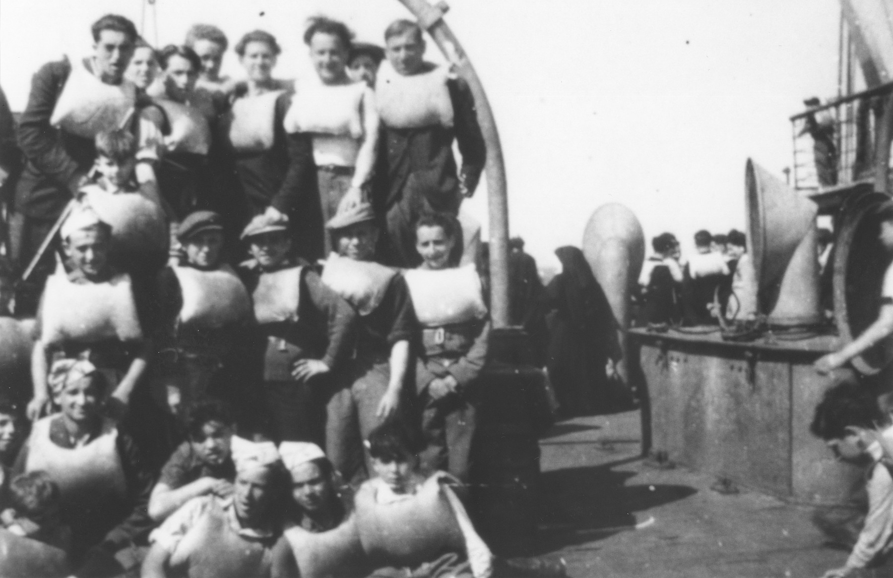 Group portrait of children wearing life jackets on board the SS Champollion during the voyage to Palestine.