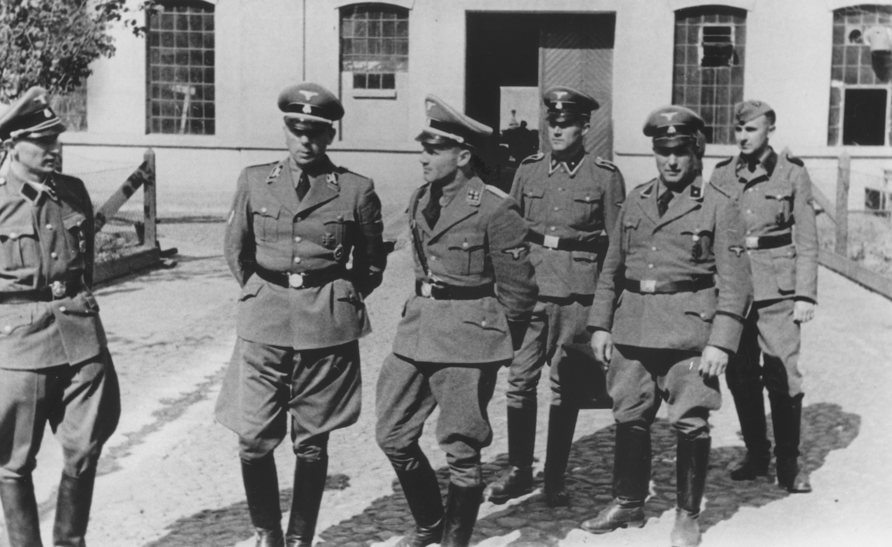 Nazi officials pay a visit to the Jugendschutzlager Litzmannstadt, a concentration camp for Polish juveniles in Lodz.

Pictured second from the left is SS-Brigadefuehrer Otto Hofmann.