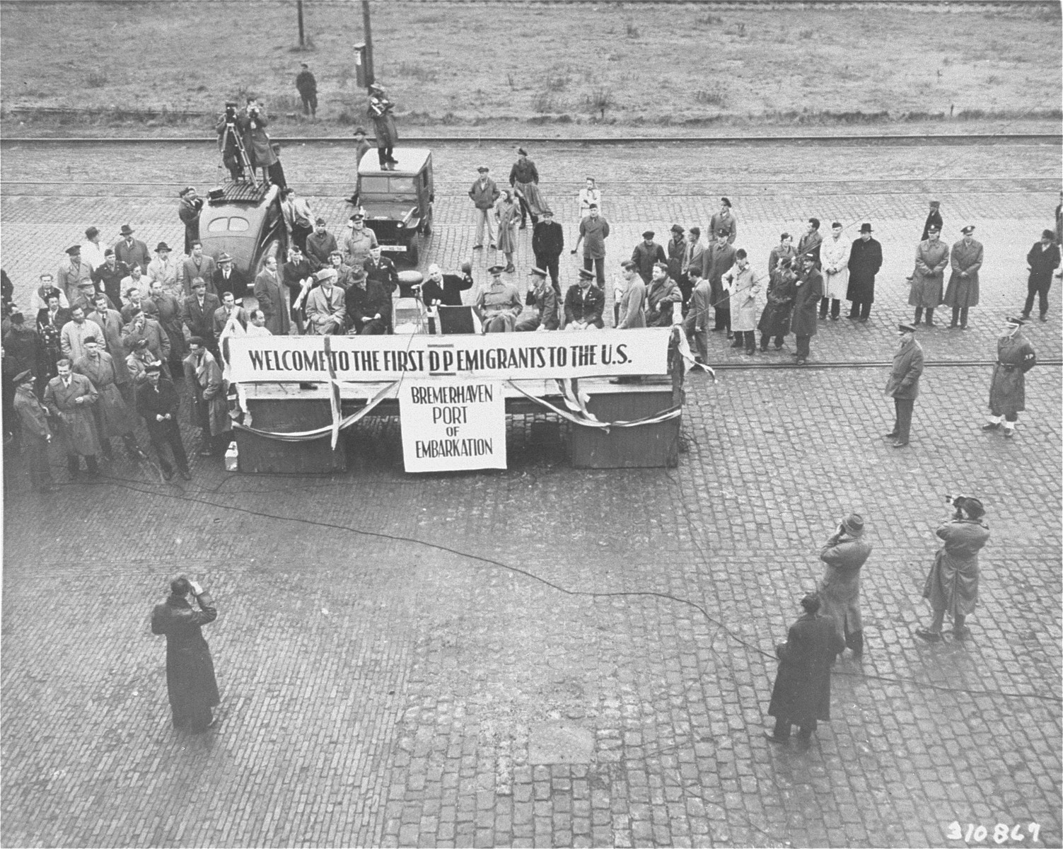 Ugo Carusi, Chairman of the Displaced Persons Commission, delivers a speech at the port of Bremerhaven before the departure of the General Black for New York.