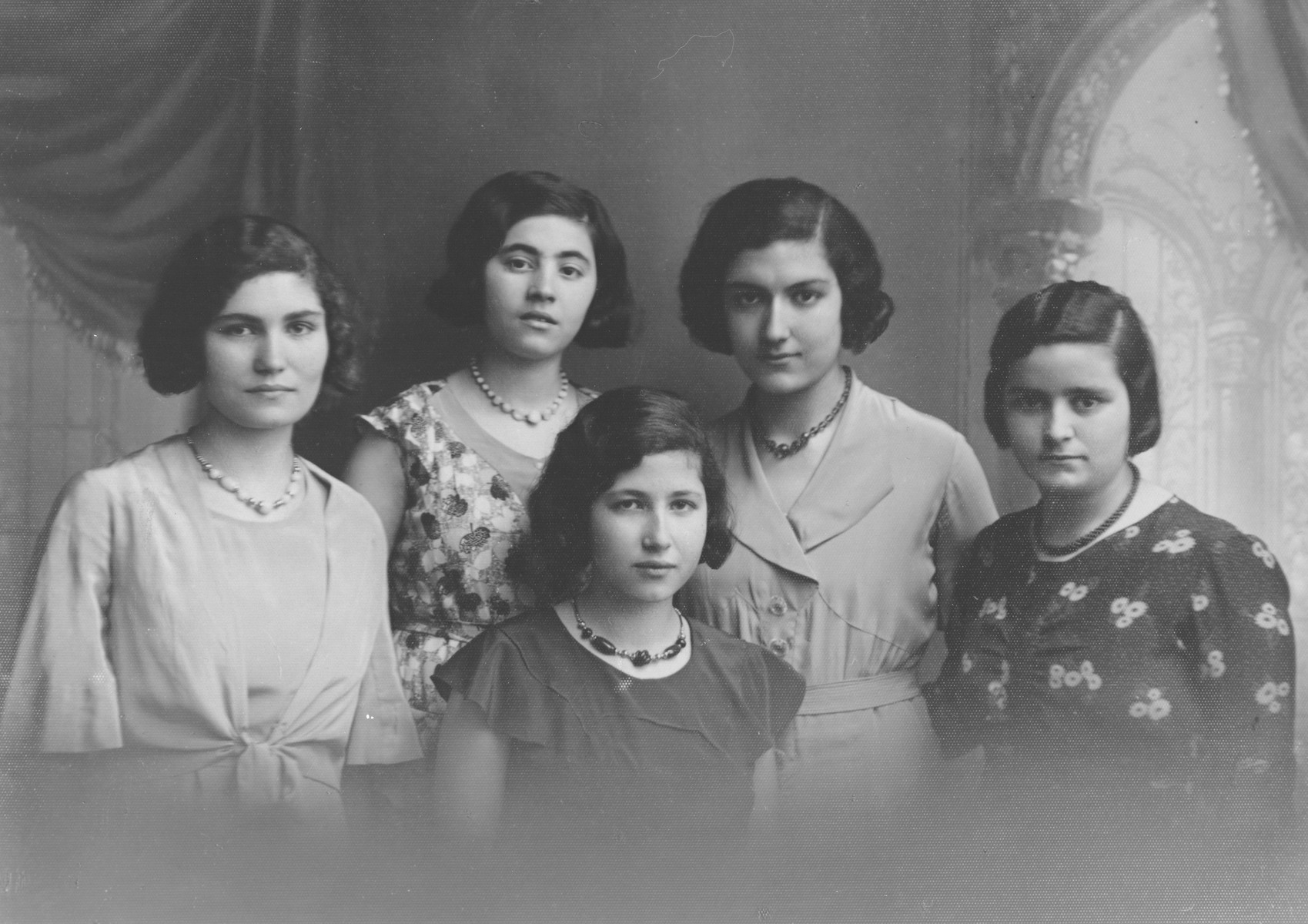 Portrait of five young Albanian women.

Pictured are three sisters and two cousins: Jeannette Matathia (later Levis), Henriette Matathia (later Levis), Fortune Jacoel (perished in Auschwitz), Mathile Matathia (later Sebetai) and Anna Levis (later Osmos).