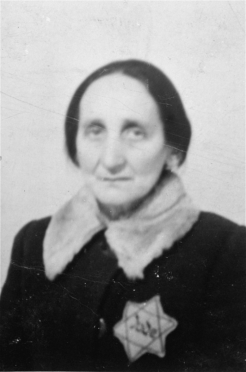 Portrait of an elderly Jewish woman wearing a Jewish badge in the Olkusz ghetto.

Pictured is the mother of donor, Rose Grinbaum.