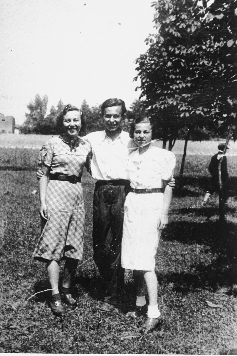 Three young people pose outside in Konskie, Poland.