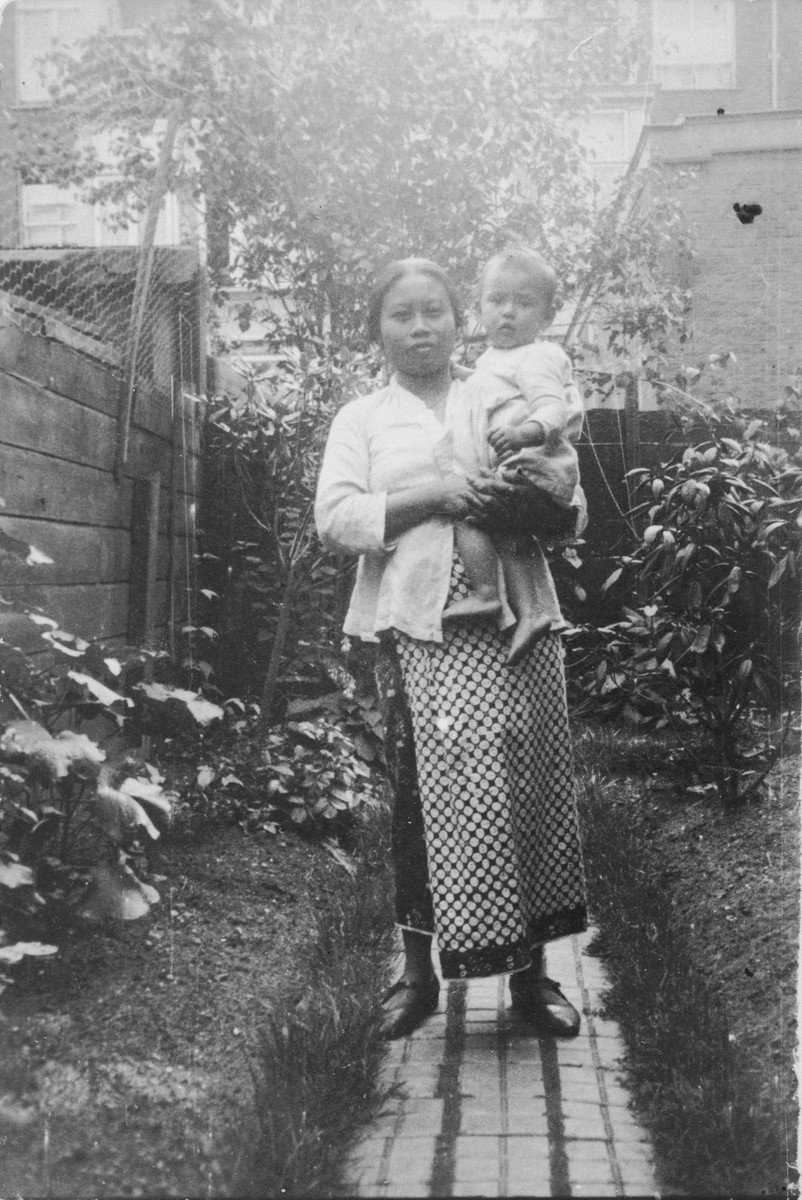 Mima Saïna poses with Alfred Münzer, a Jewish child who is living in hiding in the home of her employer, Tolé Madna.
