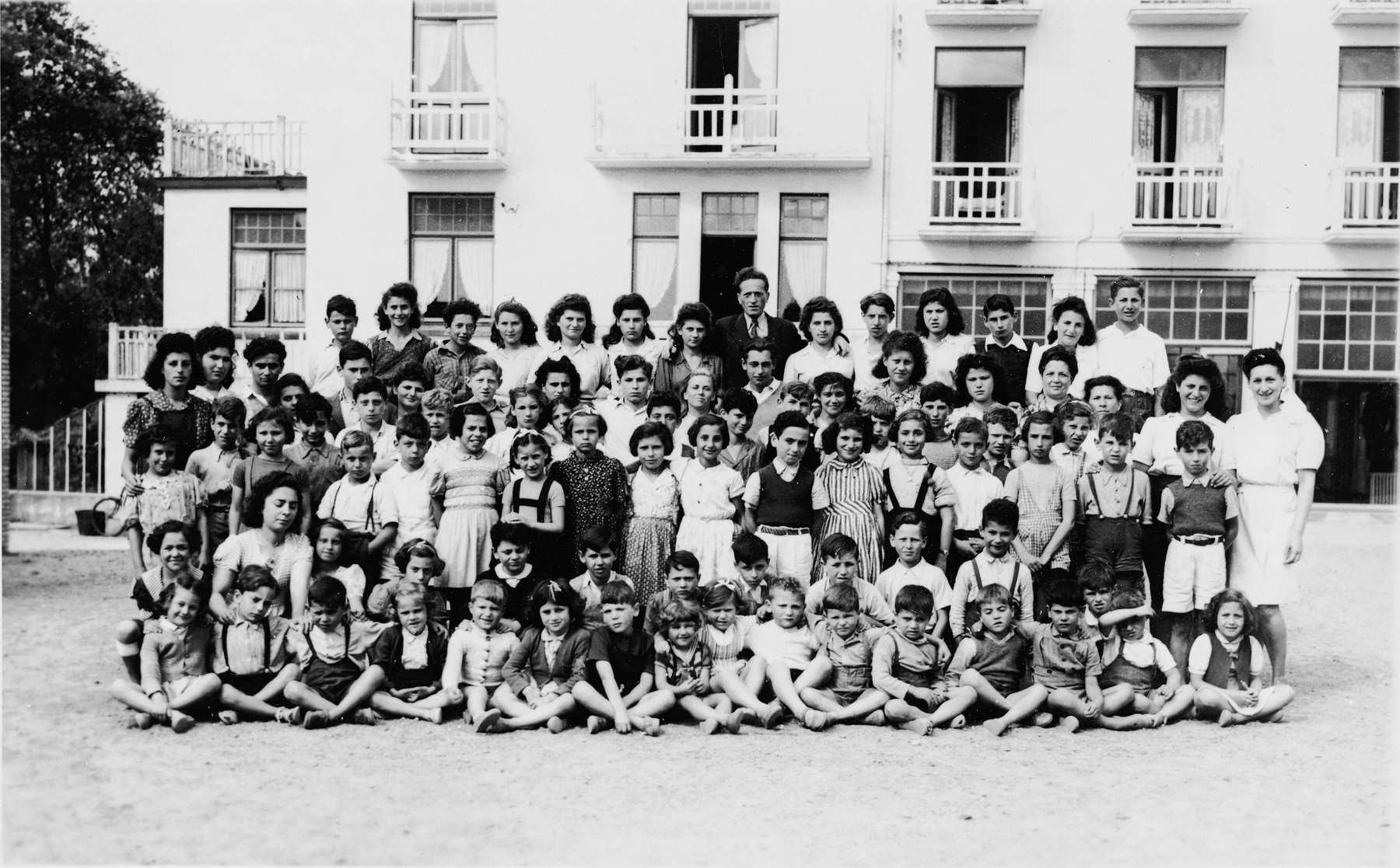 Group portrait of children in a home in Antwerp after the war.