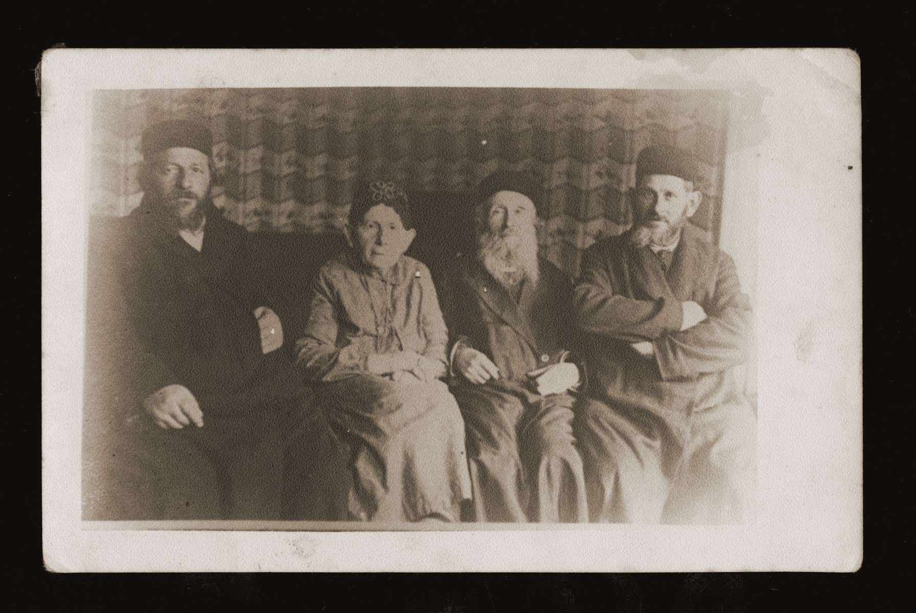 Chana Pesia Gerlic Malach and her husband, Aron Josef Malach are seated in the middle.  On the left is Abraham Gerlic, Chana Pesia's brother and on the right is Zishe Gerlic, another brother of Chana Pesia.

Chana Pesia and Aron Josef had eight sons.  Their second son, Refuel Hirsh, donor's grandfather,  and Malka Ruchel Malach of Dabrowa Gornicza, had seven children. 1. Yitzhak Mordechai (married Sara Ruda Malach), who had a son, Abraham ? (b. 1937); 2. Zishe (married Mania); 3. Syma (married Dawid?); 4. Frimet; 5. Velvel (married Itka) 6. Ester;  7. Abraham.

Zishe, the second son of Refuel Hirsh and Malka Ruchel Blum Malach, was born in 1916 in Dabrowa.  He married Frymcia Finkelsztajn in 1937.  After the German invasion the couple fled to the Soviet Union, but were separated during their flight.  Zishe was deported to Siberia, where he  met Etta Rusinek.  Dawid Malach, their son, was born in 1943.  After the liberation Zishe returned to Dabrowa, where he married Mania Adlerfliegel (from Bedzin).  They remained in Poland, where their two daughters, Giza and Sima, were born, until 1957, when the family left for Israel.