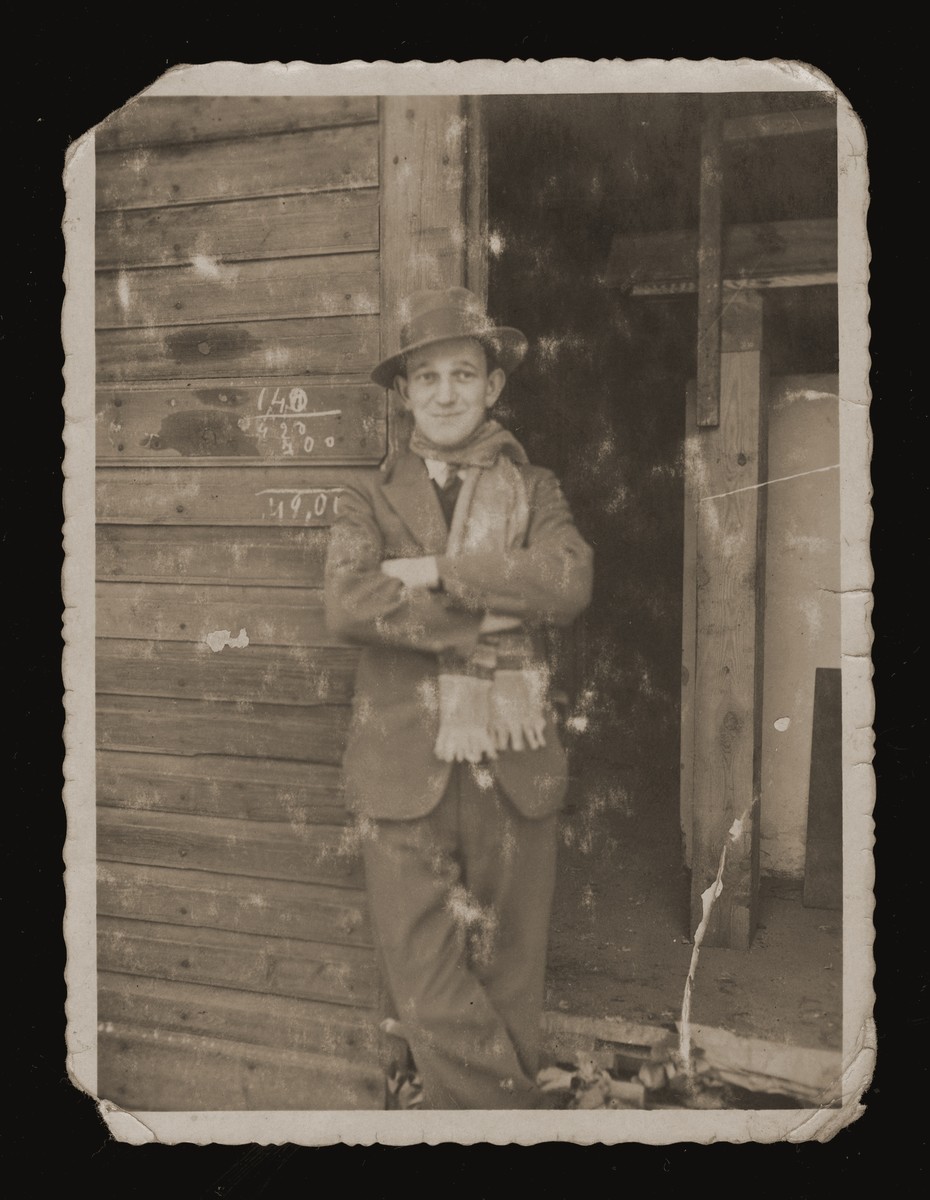 Chaim Bajtner stands in the doorway of a wooden shed in Sosnowiec.