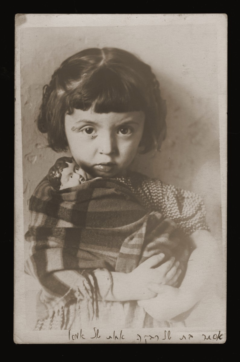 Portrait of a young Jewish girl holding a porcelain doll.

Pictured is Esther Yocheved Meiersdorf.