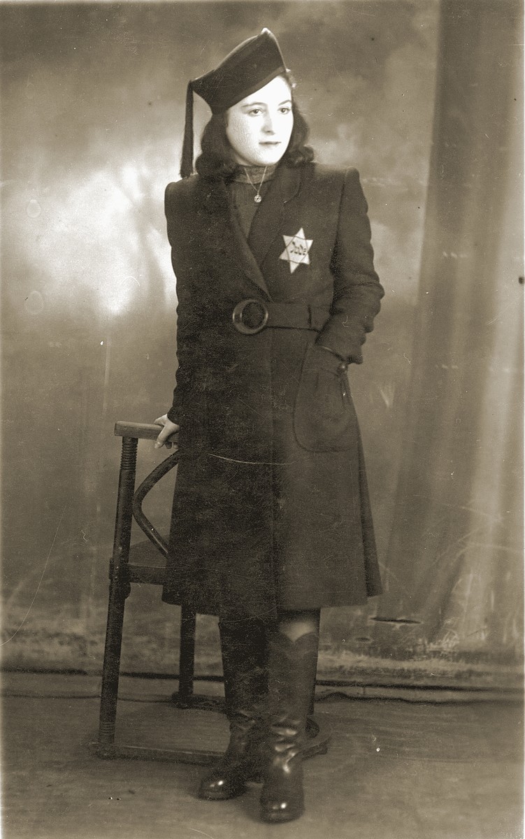 Studio portrait, taken in th Bedzin ghetto, of Mania Cawadel wearing a Jewish star.