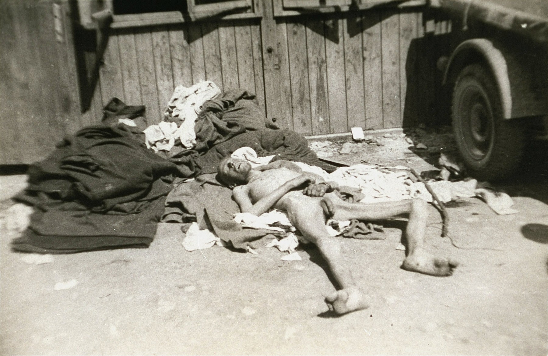 A former prisoner lies outside a barracks in the newly liberated Ebensee concentration camp.  It is not clear if he is alive or dead.