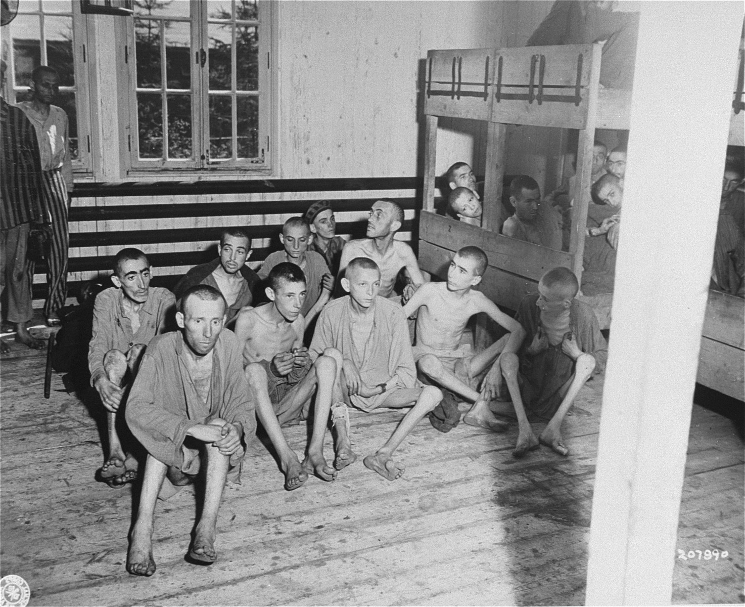 A group of emaciated survivors in the infirmary barracks for Jewish prisoners in the Ebensee concentration camp.

Among those pictured is George Havas (front row, second from the right).