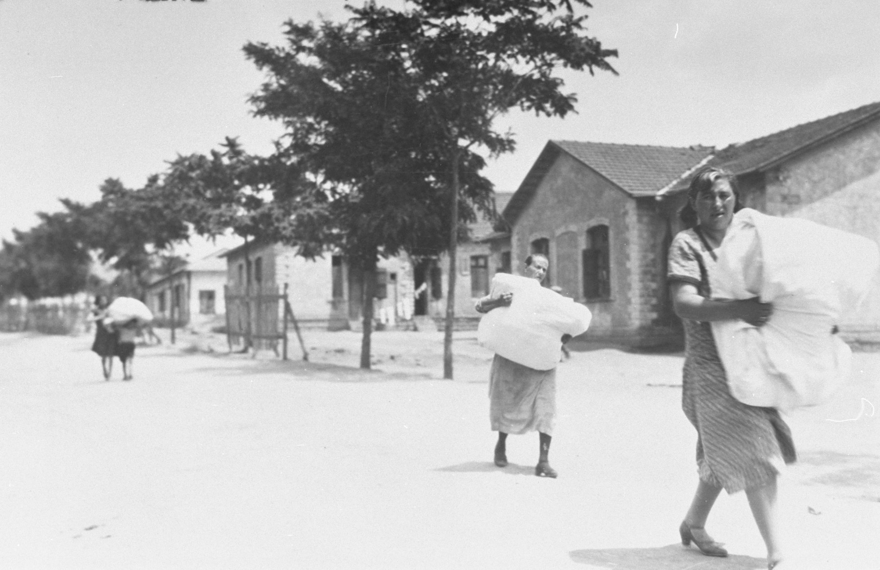 Jewish women leave their homes out of fear of another attack after the pogrom of June 29, 1931.