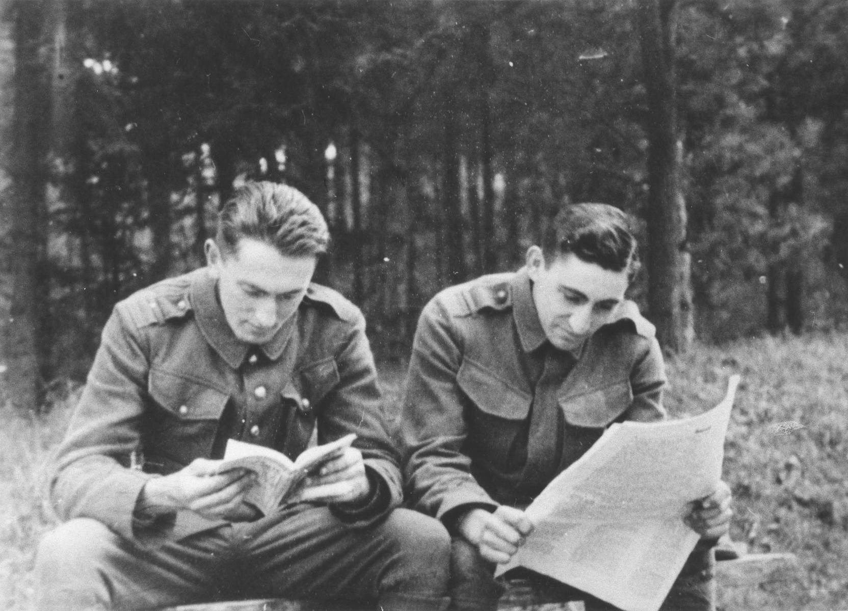 Two Jewish members of the Sixth Labor Battalion (VI Prapor) read outside at a Slovak labor camp.