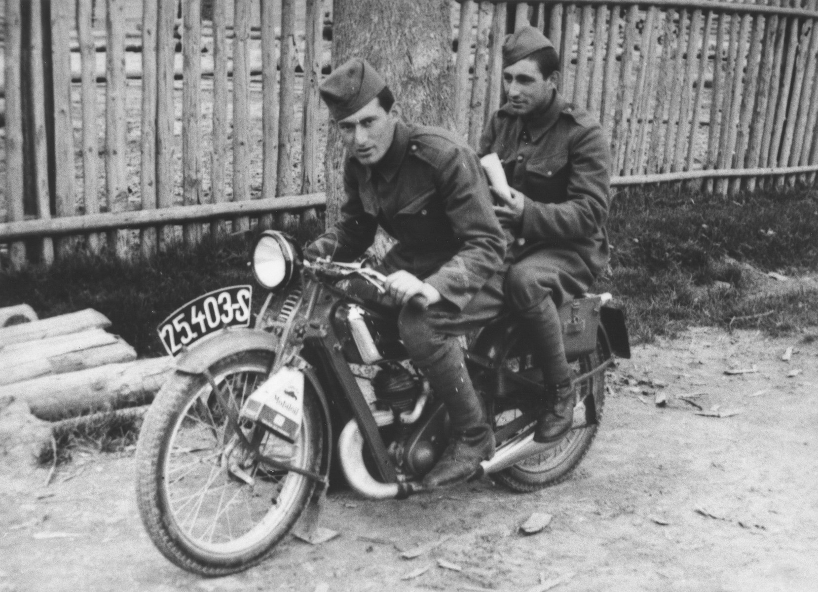 Two Jewish members of the Sixth Labor Battalion (VI Prapor) ride a motorcycle at a Slovak labor camp.