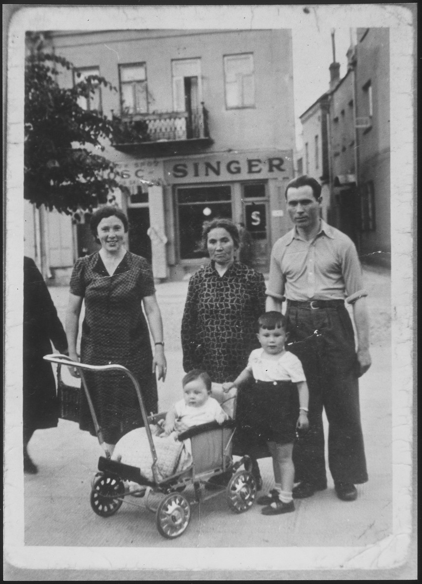 The Ejszyszki family poses on a commercial street in Eisiskes.

Those pictured are Gedaliah Ejszyszki, his wife Chaya, mother-in-law and children.
