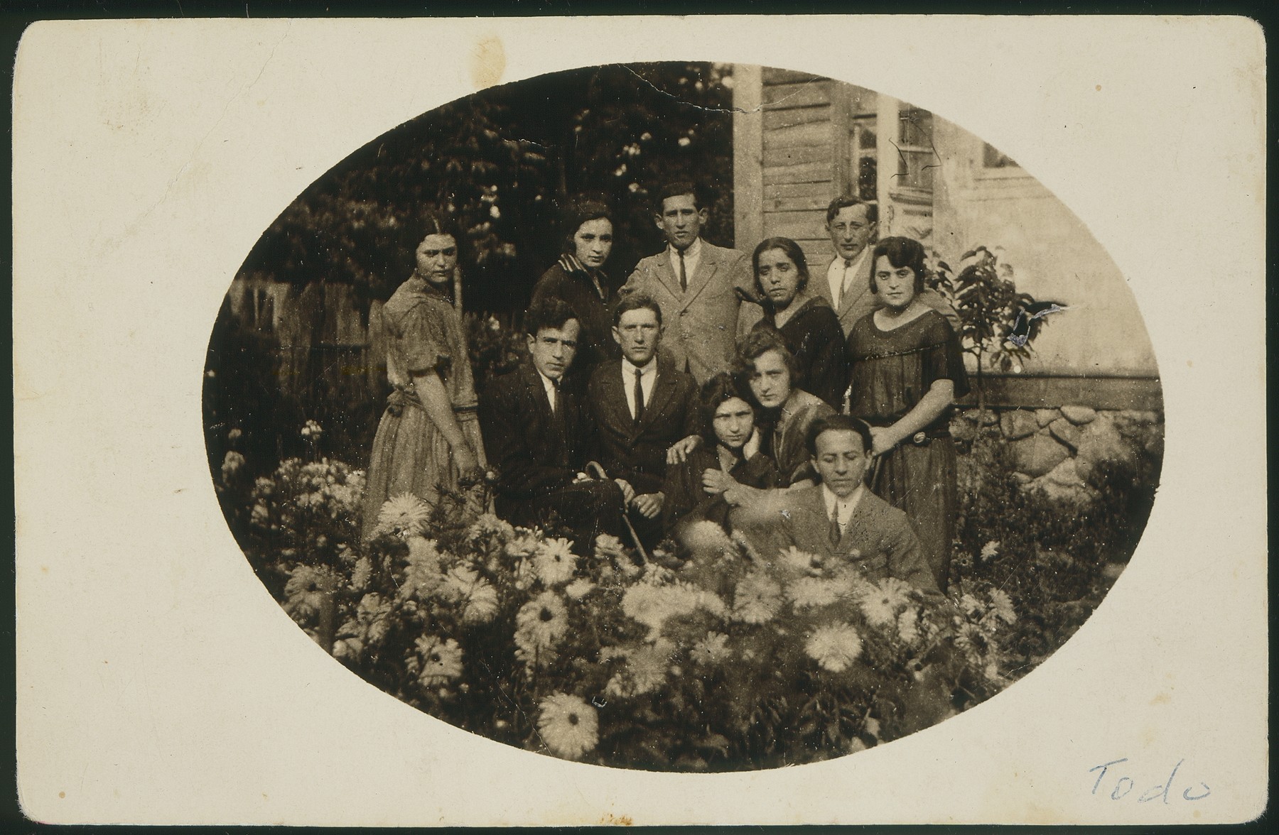 Dora Zlotnik Berkowicz gathers in a garden with friends in honor of some of their forthcoming immigration to Palestine.

The photo is inscriberd with the following words:  "The last minutes in Vasilishok.  Not always are words sufficient."  Dora also immigrated to Palestine a few years later.