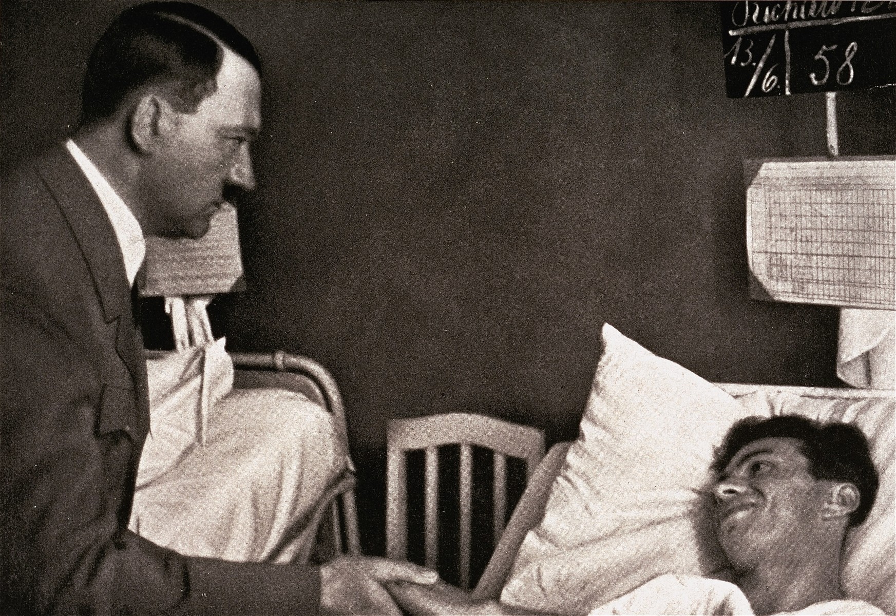 Adolf Hitler visits a hospital patient, who was one of "the victims of Reinsdorf.".