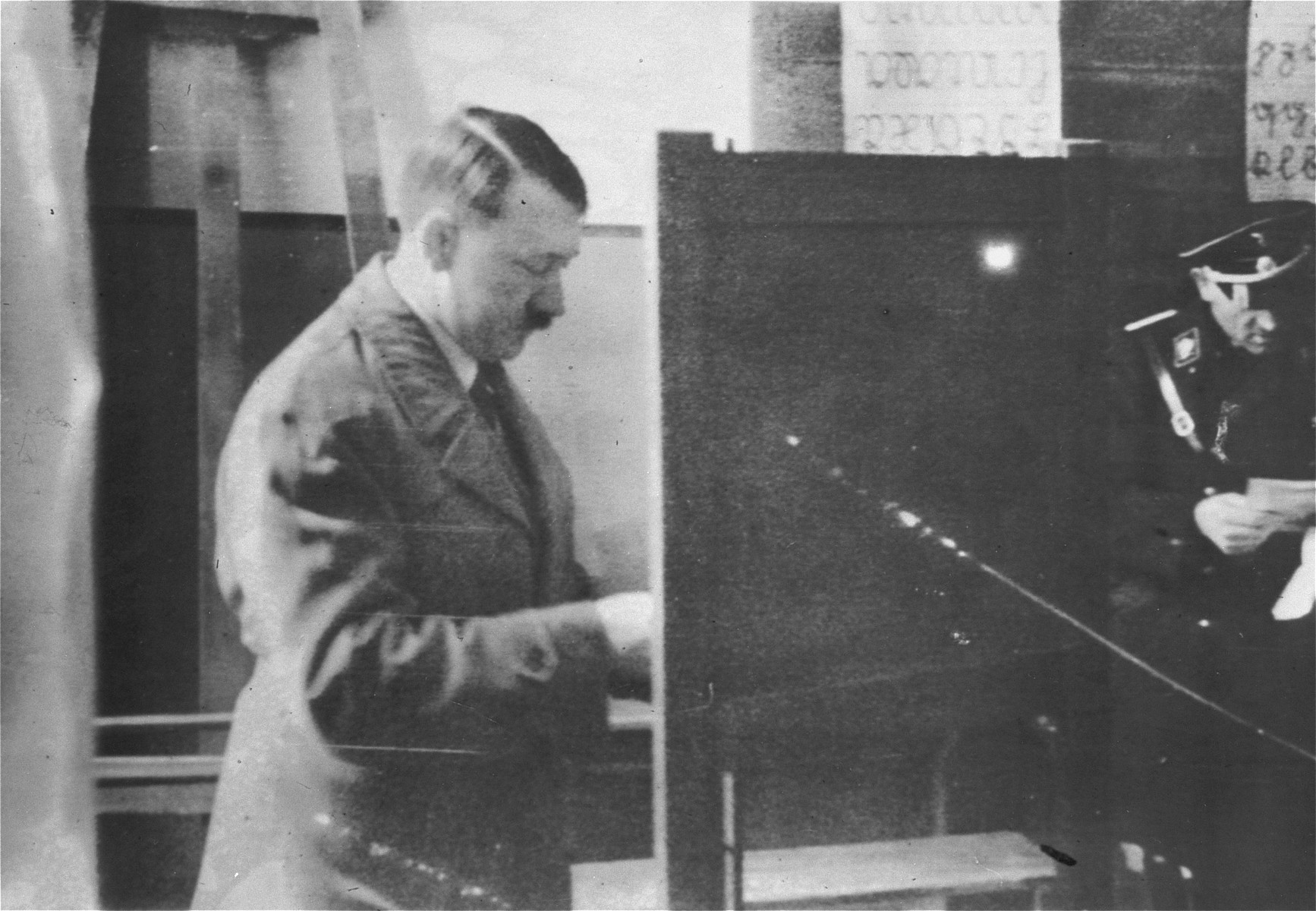 Adolf Hitler casts his vote at a Berlin polling station set up in a schoolroom.