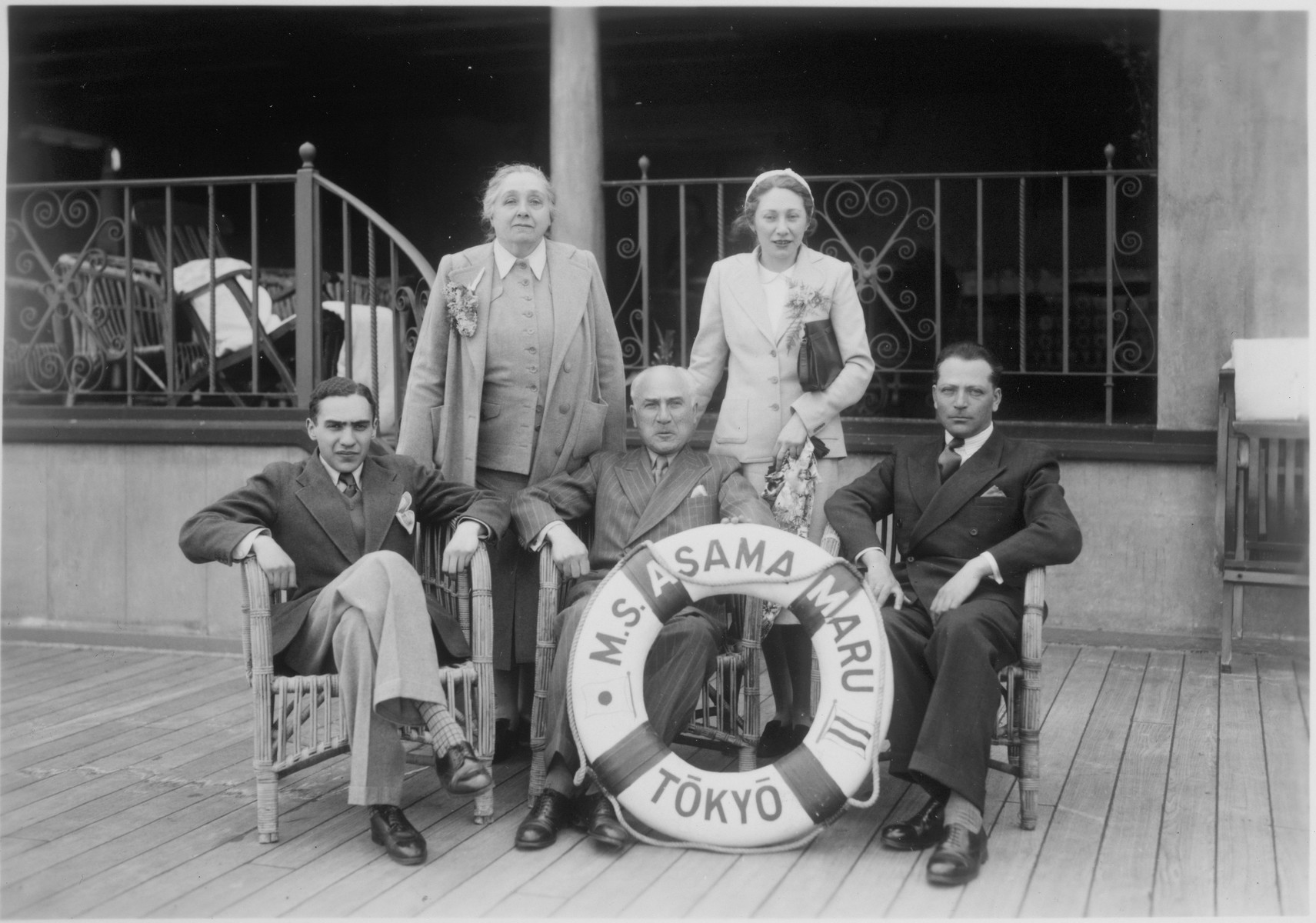 A group of Jewish refugees gather on the deck of the Asama Maru en toute from Japan to Canada.

Pictured in the front row, from left to right: Bronislaw and Zelik Honigberg, and Salomon Fishaut.   In the back row, from left to right: Maryla Honigberg and Paulina (Honigberg) Fishaut.