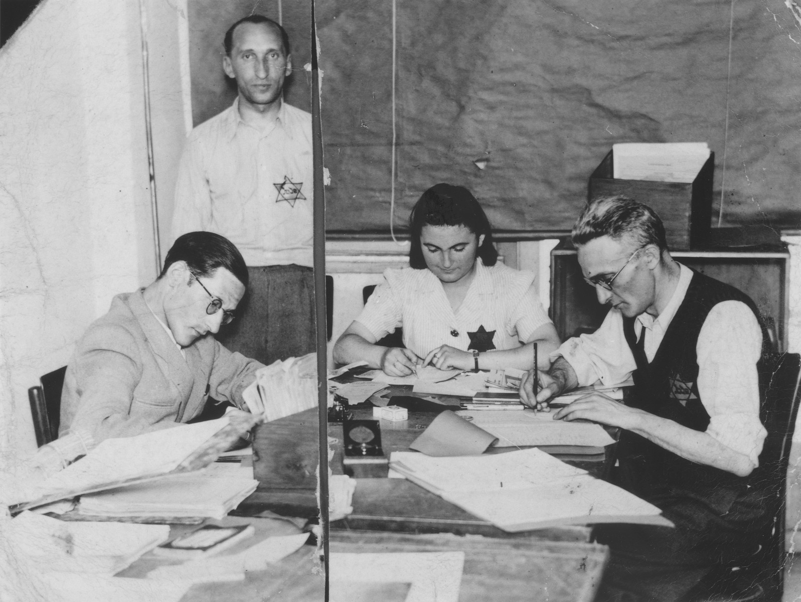 Four employees work in the office of the Leopold Michatz garment factory in the Bedzin ghetto.

Pictured from left to right are Natek Aleksandrowicz, Kahane, Hanka Granek and Hercko Brukner.