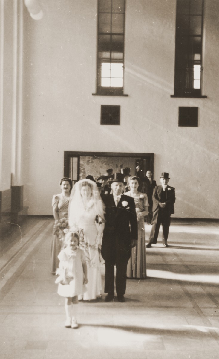 The wedding of Julius Jacob Zion to Nora de Jong at the synagogue in Enschede.

Also pictured are Wilhelmina Esther Zion, Julius' sister (behind the bride); Mientje de Jong, Nora's sister (behind the groom); and Betty Rosenbaum, the flower girl, who is Julius' niece.  Betty, who lost both her parents during the war, was adopted by Julius and Nora after their marriage.
