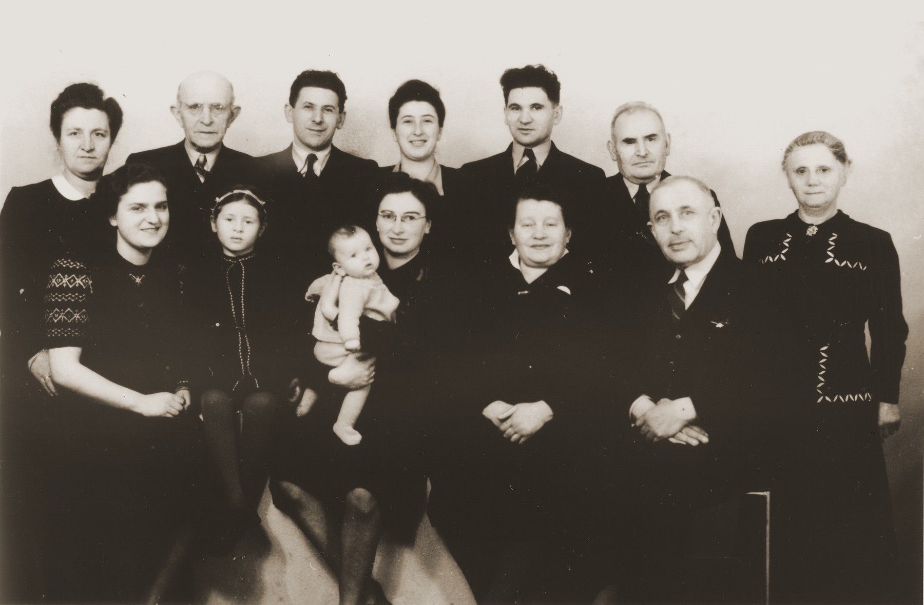 Group portrait of members of the Jewish community of Eibergen in 1947.

Pictured in the front row from left to right are: Bep Menco; Betty Rosenbaum; Nora de Jong Zion holding her daughter, Sera Elizabeth; Jenny Frank Silberberg; Jenny's husband.  In the back row from left to right are: Fie van Gelder Menco; Jenny's brother-in-law; Julius Zion; Bep Meijer; Sallie Zion; Lehman van Gelder; Anna van Gelder.