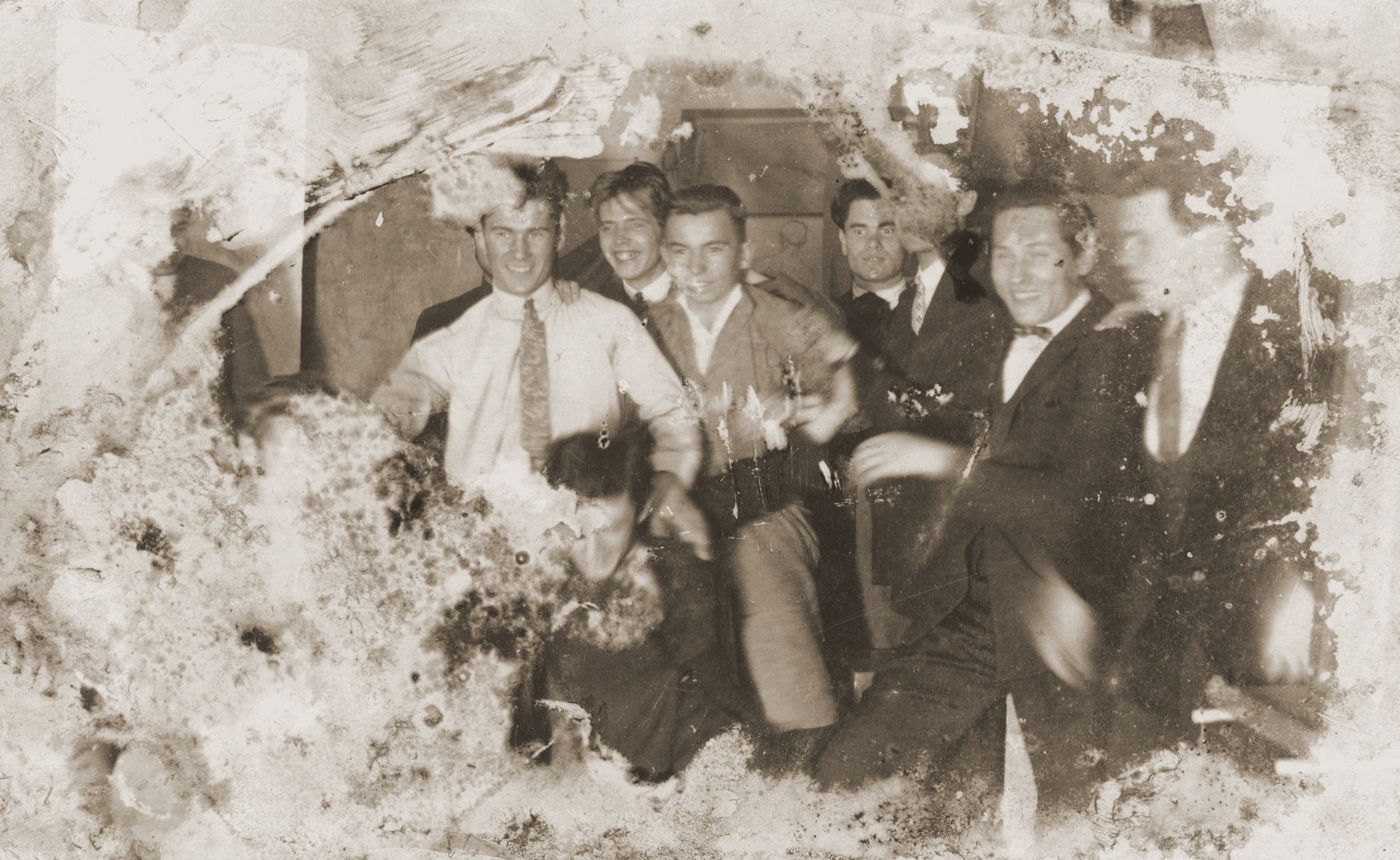 Damaged photograph of a group of male friends in Kovno, Lithuania that survived the destruction of the Kovno ghetto.

Among those pictured is the artist Jacob Lifschitz (center).  The photograph was buried with the artist's drawings shortly before the liquidation of the ghetto, and retrieved by his wife after the liberation.