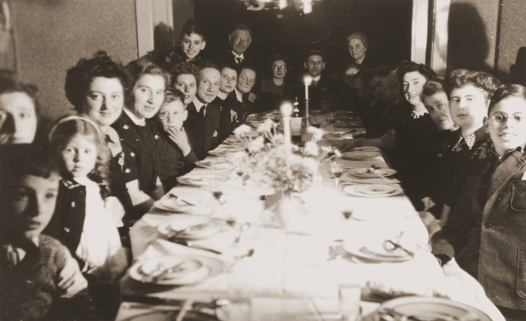 Engagement party for Julius Jacob Zion and Nora de Jong at the de Jong home in Enschede.

Among those pictured are the bride and groom (at the head of the table); the bride's father and mother (on either side of the bride and groom); Bep Meijer (fourth from the front on the right side); Frieda Zion (second from the front on the right side); and Betty Rosenbaum (the child second from the front on the left side).