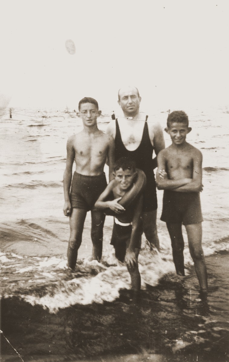 Abraham Harmatz poses with his three sons, Zvi Hirsch, Joseph and Ephraim, at the seashore in Palanga, Lithuania.