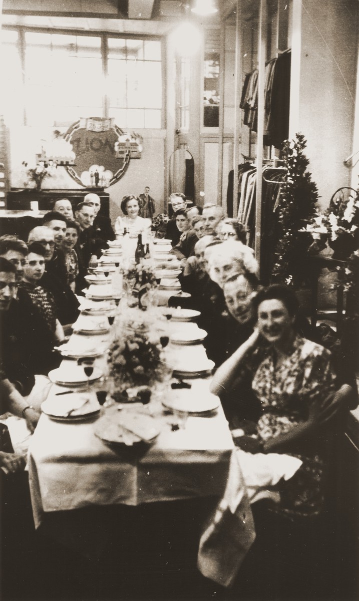 Festive dinner celebrating the reopening of the Zion family business at the store in Eibergen.

Among those pictured are Bep Meijer (front, right side) and Julius Zion (fifth from the front on the left side).  From August 1942, when it was confiscated, until April 1945, the Zion clothing and fabric store had been used by the Germans as a military warehouse and barracks.