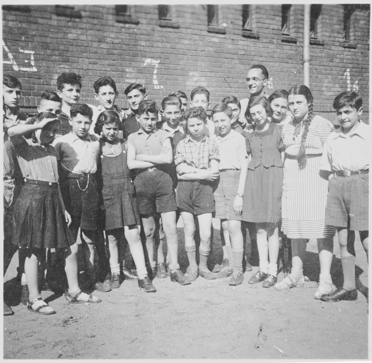 Jizchak Schwersenz, director of the Youth Aliyah school in Berlin, poses outside with some of his students.