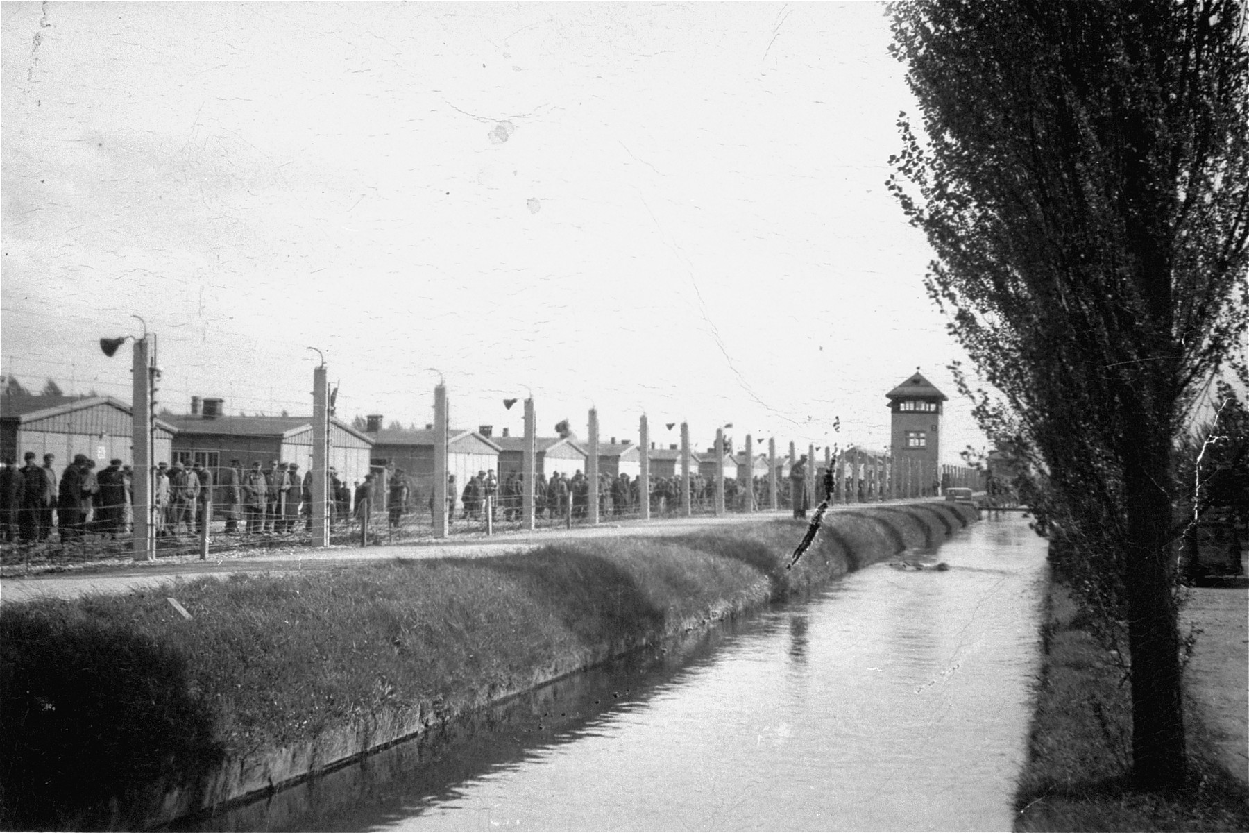 The barbed-wire fence and moat that surrounded the Dachau concentration camp.