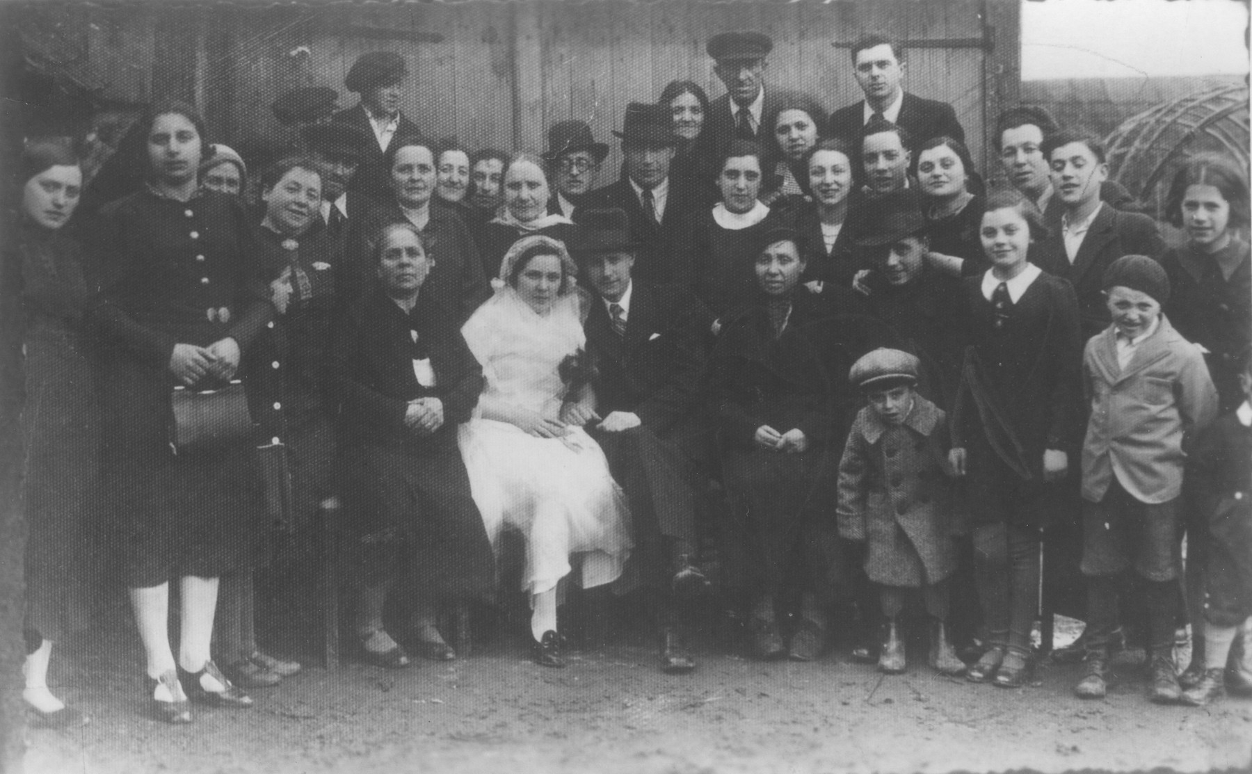 Family and friends pose with the bride and groom at a Jewish wedding in Telsiai, Lithuania.

The couple perished during World War II.