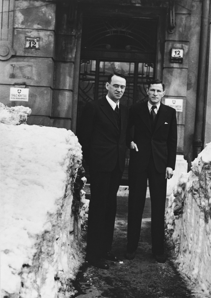 Charles (Carl) Lutz (left) stands with his colleague, Mr. Steiner, outside one of the consulates in Budapest between two mounds of snow.